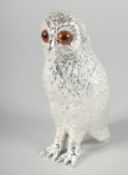 A HEAVY SILVER PLATED OWL SUGAR SHAKER with glass eyes. 6ins high.