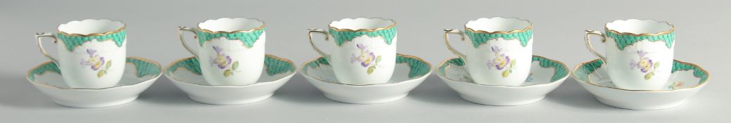 A SET OF FIVE HEREND CUPS AND SAUCERS painted with flowers.