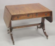 A GOOD REGENCY MAHOGANY SOFA TABLE with folding flaps, two small frieze drawers, dummy to the