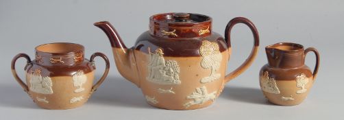 A ROYAL DOULTON STONEWARE THREE PIECE TEA SET: tea pot, sugar basin and milk jug,
