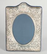 A SILVER OVAL UPRIGHT PHOTOGRAPH FRAME. 7.5ins x 5ins.