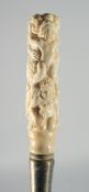 A CARVED BONE EROTIC HANDLED WALKING STICK.