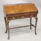 AN 18TH CENTURY WALNUT BUREAU with fall front and fitted interior, three drawers below a later
