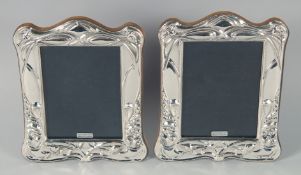 A PAIR OF SILVER FRAMED UPRIGHT PHOTOGRAPH FRAMES 7.75ins x 6ins.
