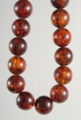 AN AMBER TWENTY ONE BEAD NECKLACE.