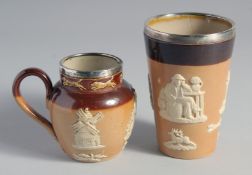A ROYAL DOULTON STONEWARE BEAKER, 4.5ins high and a milk jug, 3.5ins high, both with silver rim (