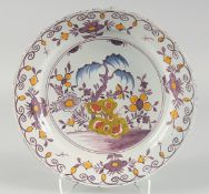 A GOOD 18TH CENTURY DUTCH FAIENCE POLYCHROME PLATE painted with flowers. 14ins diameter.