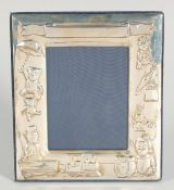 A SILVER UPRIGHT PHOTOGRAPH FRAME with toys. 6ins x 5ins.