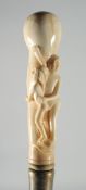 A CARVED BONE EROTIC HANDLED WALKING STICK.