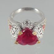 A SILVER AND RUBY HEART RING.