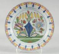 A GOOD 18TH CENTURY DUTCH FAIENCE POLYCHROME PLATE painted with flowers. 14ins diameter.