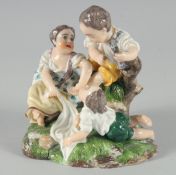 A PORCELAIN GROUP Of CHILDREN PLAYING 5.5ins high.