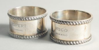 TWO BOXED SILVER SERVIETTE RINGS.