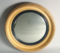 A GILDED WOOD CONVEX MIRROR in the Regency style. 2ft 4ins diameter.