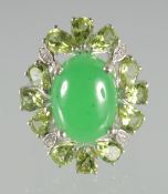 A SILVER JADE AND PERIDOT RING.