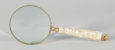 A MAGNIFYING GLASS with a mother of pearl handle.