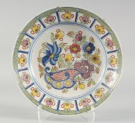A GOOD 18TH CENTURY DUTCH FAIENCE POLYCHROME PLATE painted with flowers. 14ins diameter.