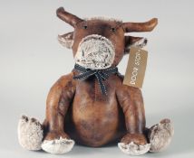A COW LEATHER AND CLOTH DOORSTOP.