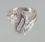 A SILVER C Z CROSS OVER RING.