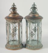 A GOOD PAIR OF TIN GLAZED CIRCULAR LANTERNS on curving stands with carrying handles. 27ins.
