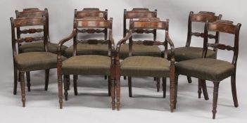 A SET OF EIGHT REGENCY BACK DINING CHAIRS, two with arms, padded seats on turned legs.
