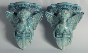 A GOOD PAIR OF TURQUOISE POTTERY WINGED ANGEL BRACKETS. 8.5ins high.