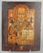 A LARGE RUSSIAN ICON, priest holding a bible. 15ins x 12ins.