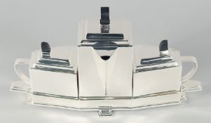 A SILVER PLATED ART DECO DESIGN TEA POT SET on a stand. 16ins long.