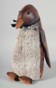 A PENGUIN LEATHER AND CLOTH DOORSTOP.