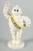 A SMALL PAINTED CAST IRON MICHELIN MAN. 6.5ins high.