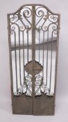 AN IRON FOLDING GATE with mirrored back. 6ft high.