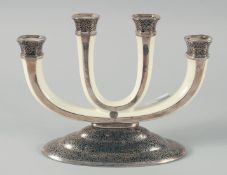 A ROSENTHAL ART DECO FOUR LIGHT PORCELAIN CANDLESTICK on a silvered base. 8.5ins high.