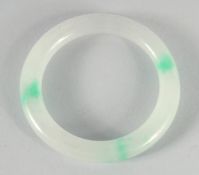 A CELADON JADE BANGLE. 2.75ins diameter.