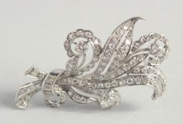 A VERY GOOD DIAMOND FLORAL BROOCH in a Harrods box.