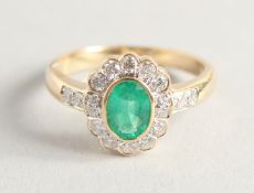 AN 18CT YELLOW GOLD, EMERALD AND DIAMOND RING.