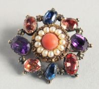 A MULTI- COLOURED STONE BROOCH.