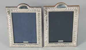 A PAIR OF SILVER FRAMED UPRIGHT PHOTOGRAPH FRAMES 7.25ins x 5.25ins.
