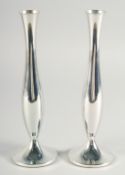 A PAIR OF MODERN SILVER CIRCULAR CANDLESTICKS. 8ins high.