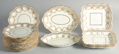 A SET OF WHITE AND GILT DISHES with ribbon and garlands: an oval pair, four square, fourteen
