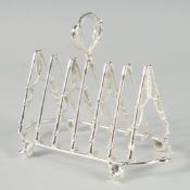 A SILVER PLATED RIDING CROP SIX DIVISION TOAST RACK on ball feet. 8ins long.