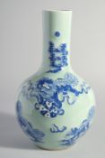 A LARGE CHINESE CELADON GROUND BLUE AND WHITE PORCELAIN VASE, decorated with foo dogs, 34.5cm high.
