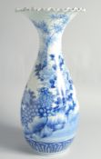 A LARGE JAPANESE BLUE AND WHITE PORCELAIN VASE, painted with flowers, the base with character