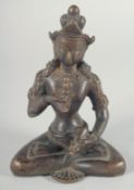 A BRONZE FIGURE OF A SEATED DEITY holding a vajra, 16cm high.