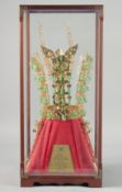 A CHUNMA CHONG GOLD CROWN, no. 188, presented in a glass display case, case 51cm x 23cm x 23cm.