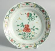 A CHINESE FAMILLE VERTE PORCELAIN DISH, painted with flora, mark to base, 21cm diameter.