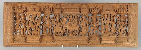 A THAI CARVED AND PIERCED RECTANGULAR WOODEN PANEL, depicting deities, animals and musicians, 73cm x
