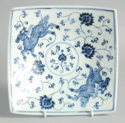A CHINESE BLUE AND WHITE PORCELAIN SQUARE FORM DISH, decorated with beasts and lotus, the base