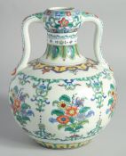 A CHINESE DOUCAI PORCELAIN TWIN HANDLE DOUBLE GOURD VASE, painted with sprays of flora, six-