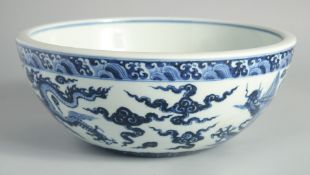 A LARGE CHINESE BLUE AND WHITE PORCELAIN DRAGON BOWL, the dragons amongst stylised clouds beneath