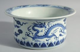 A CHINESE BLUE AND WHITE PORCELAIN BASIN, decorated with dragons, 26cm diameter.